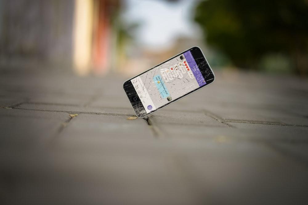 selective focus photo of iPhone balance on brick pavement